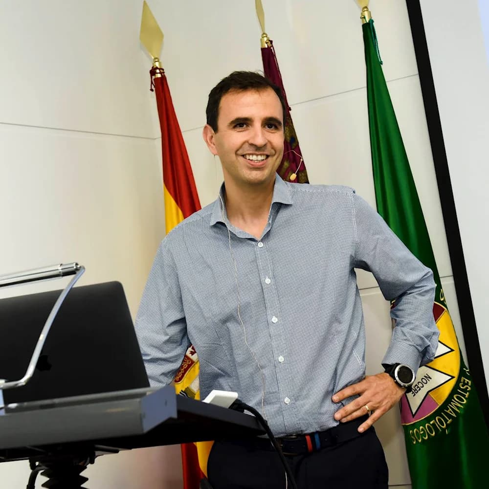 El Dr. Javier Plaza junto a las banderas de las sociedades científicas